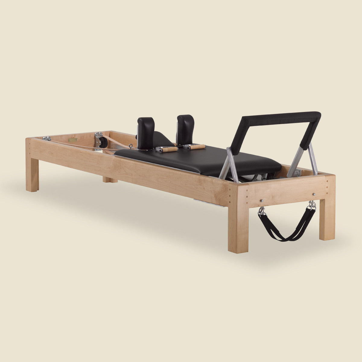 Pilates Archive Reformer machine with wooden frame, black padded carriage, shoulder blocks and straps