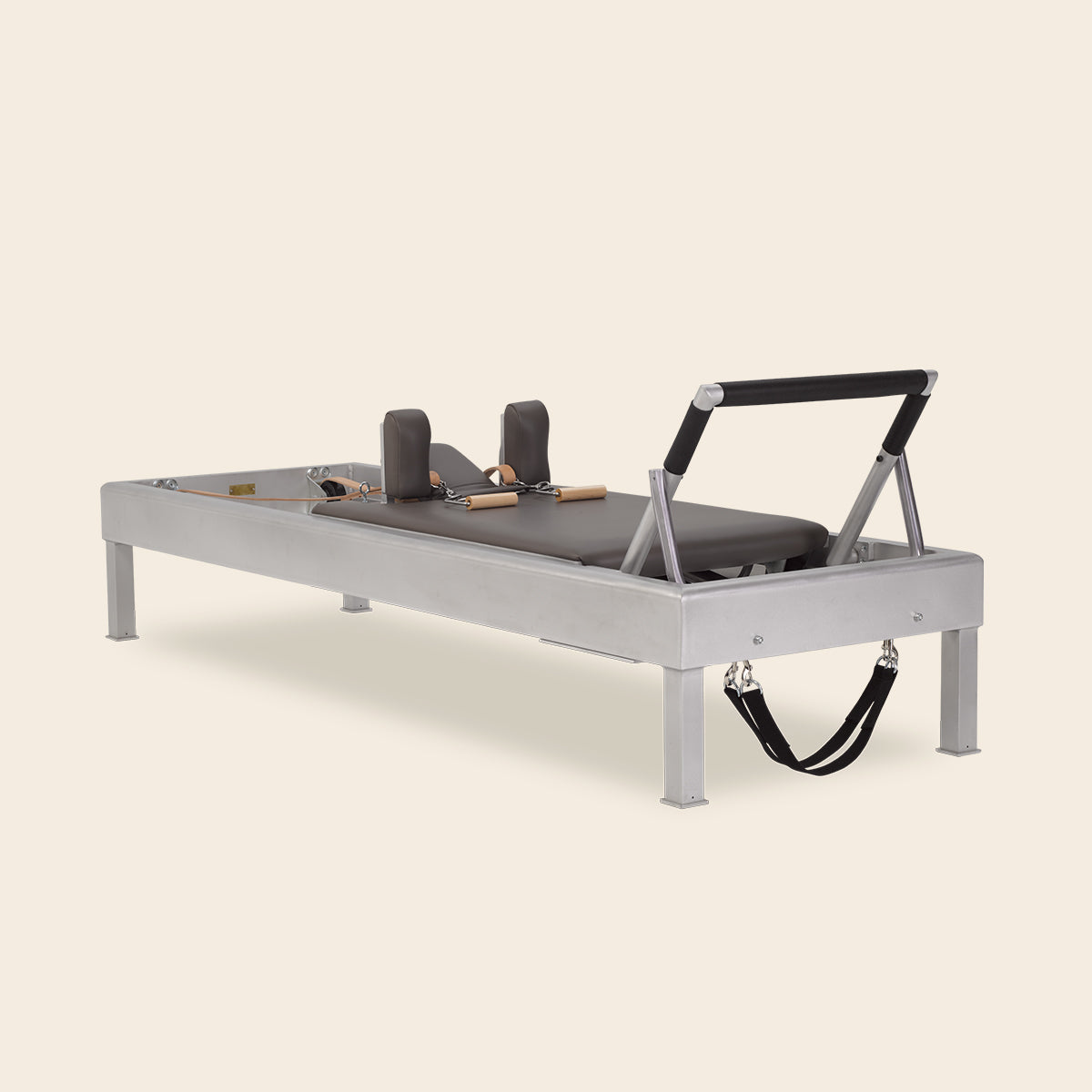 Close-up of maple wood grain and metal hardware on Pilates reformer frame